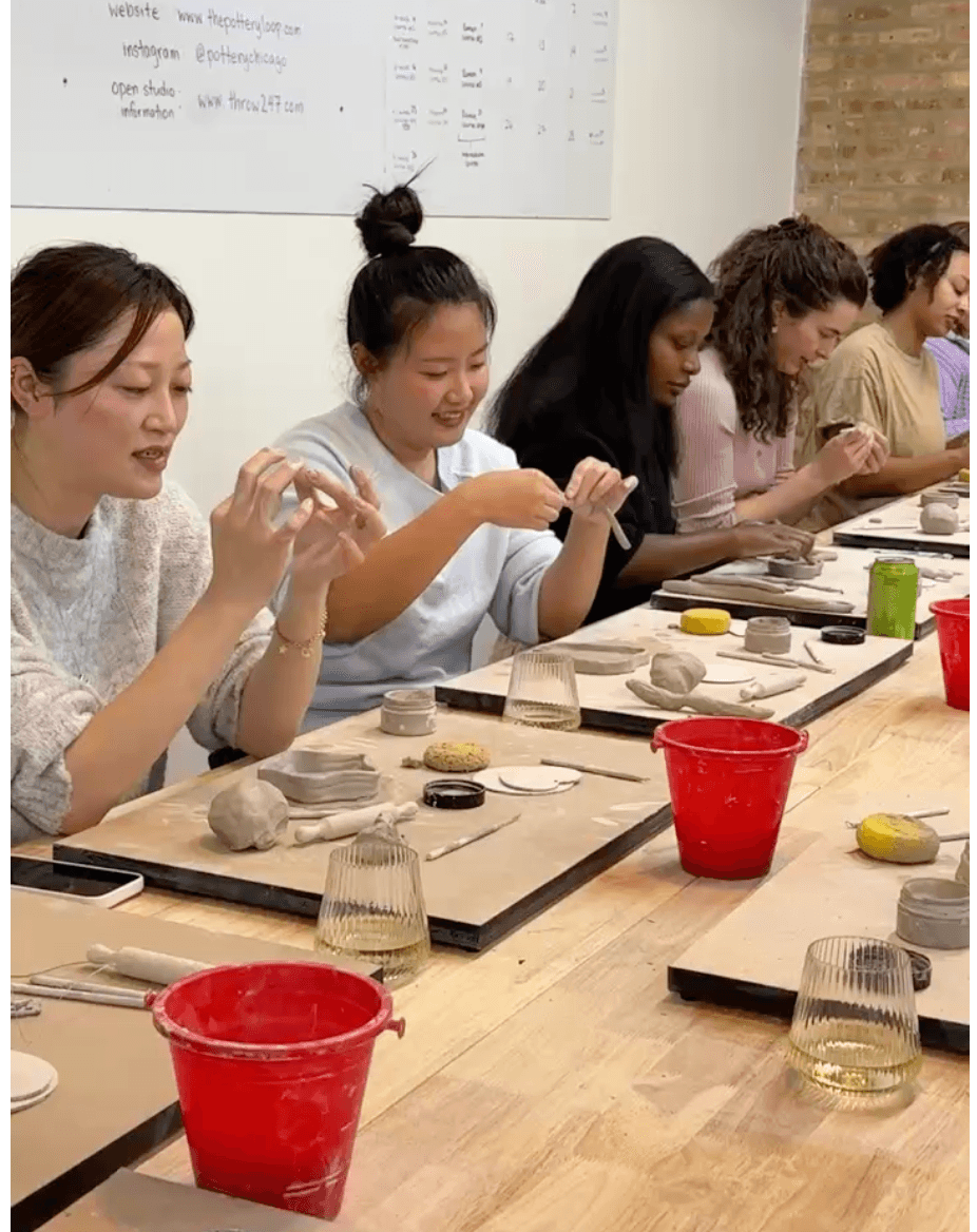 Members shaping clay at a Girl Dinner Social pottery class