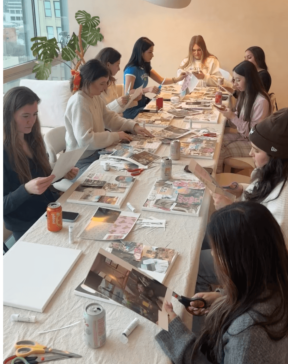Members making vision boards together at a Girl Dinner Social craft night